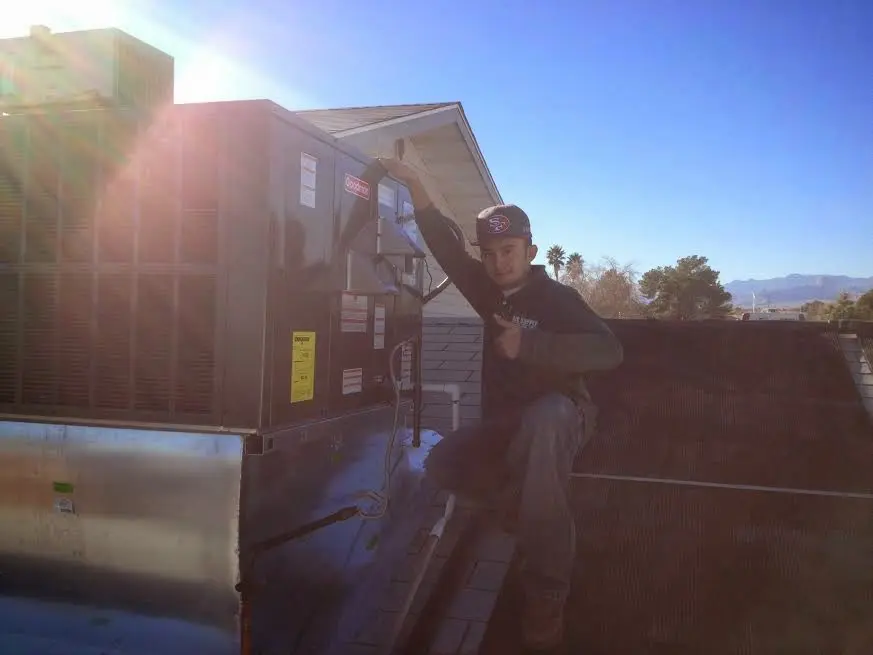 HVAC technician performing Air Duct Repair on a rooftop unit in Lucas Valley-Marinwood
